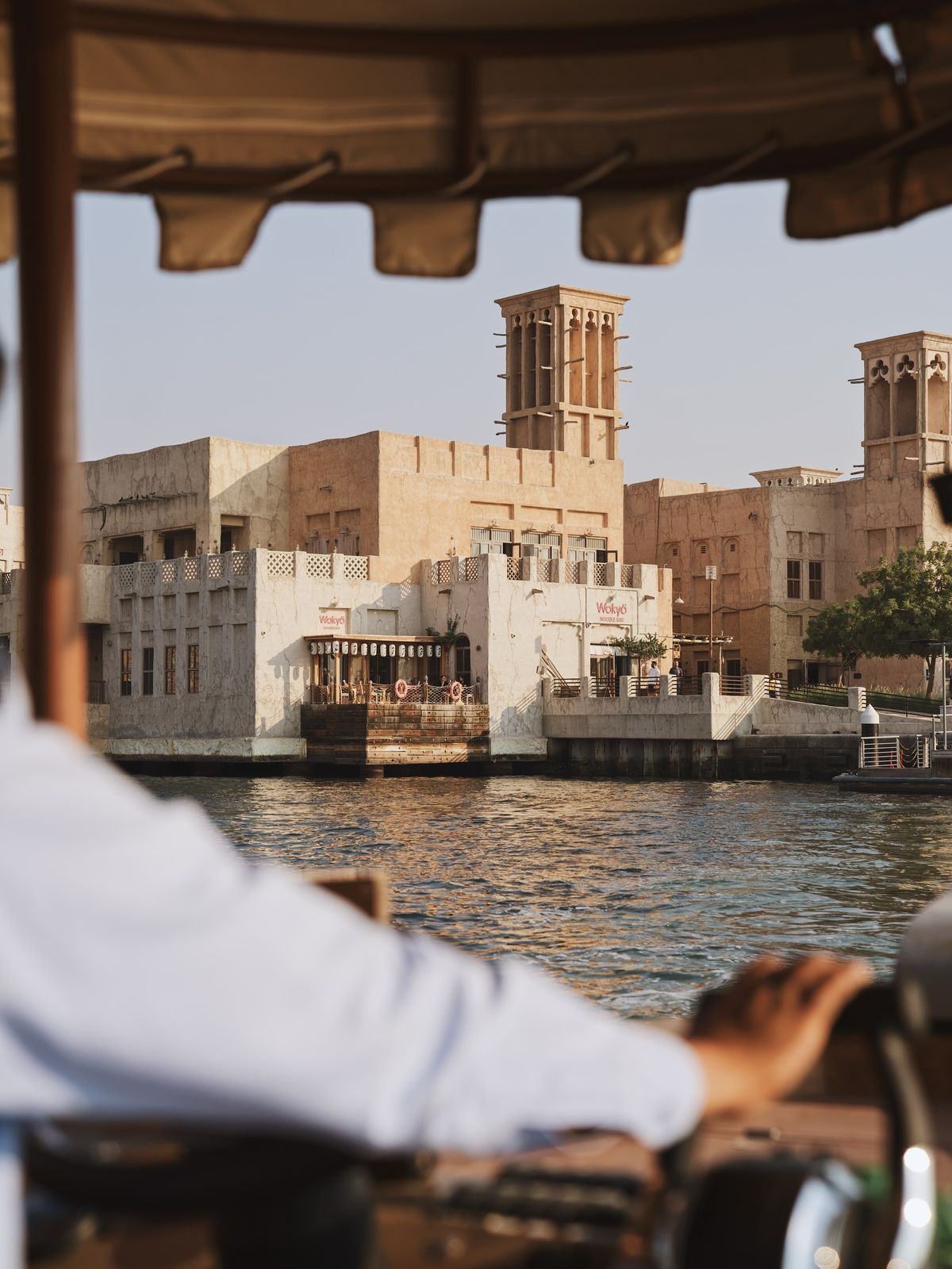 Wind towers and old buildings on the water's edge